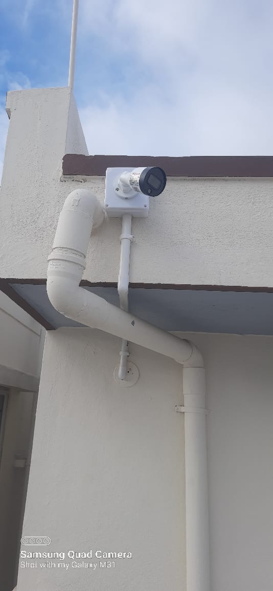 Outdoor bullet camera mounted under a roof eave